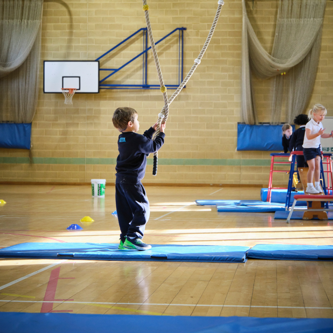 Pupil with a climbing rope in Rainey Hall