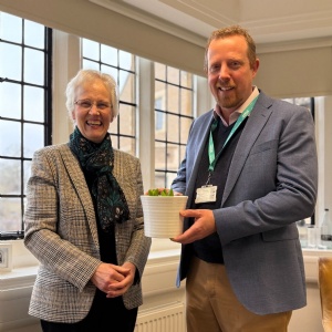 Katie Milne presenting a birthday hyacinth to Principal Richard Girvan to celebrate the 144th Birthday of Stephen Perse Cambridge