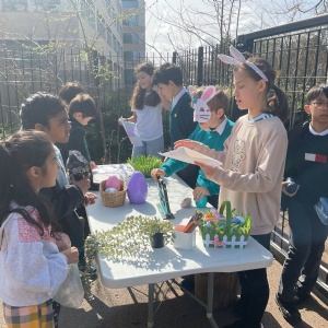 Cambridge Junior School pupils running a stall at the playground sale raising money for the House charities